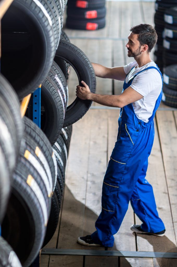 Mechanic taking a tyre from stock - DB Tyres & Mobile Fitting - Next Day Fitting Lytham St Annes